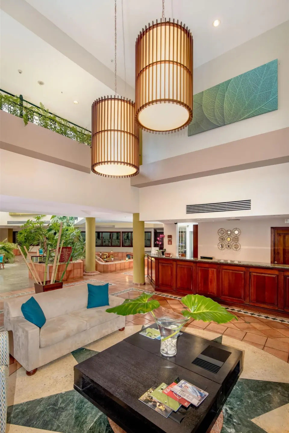 Lobby seating and reception desk at Hodelpa Garden Suites Golf & Convention Center.