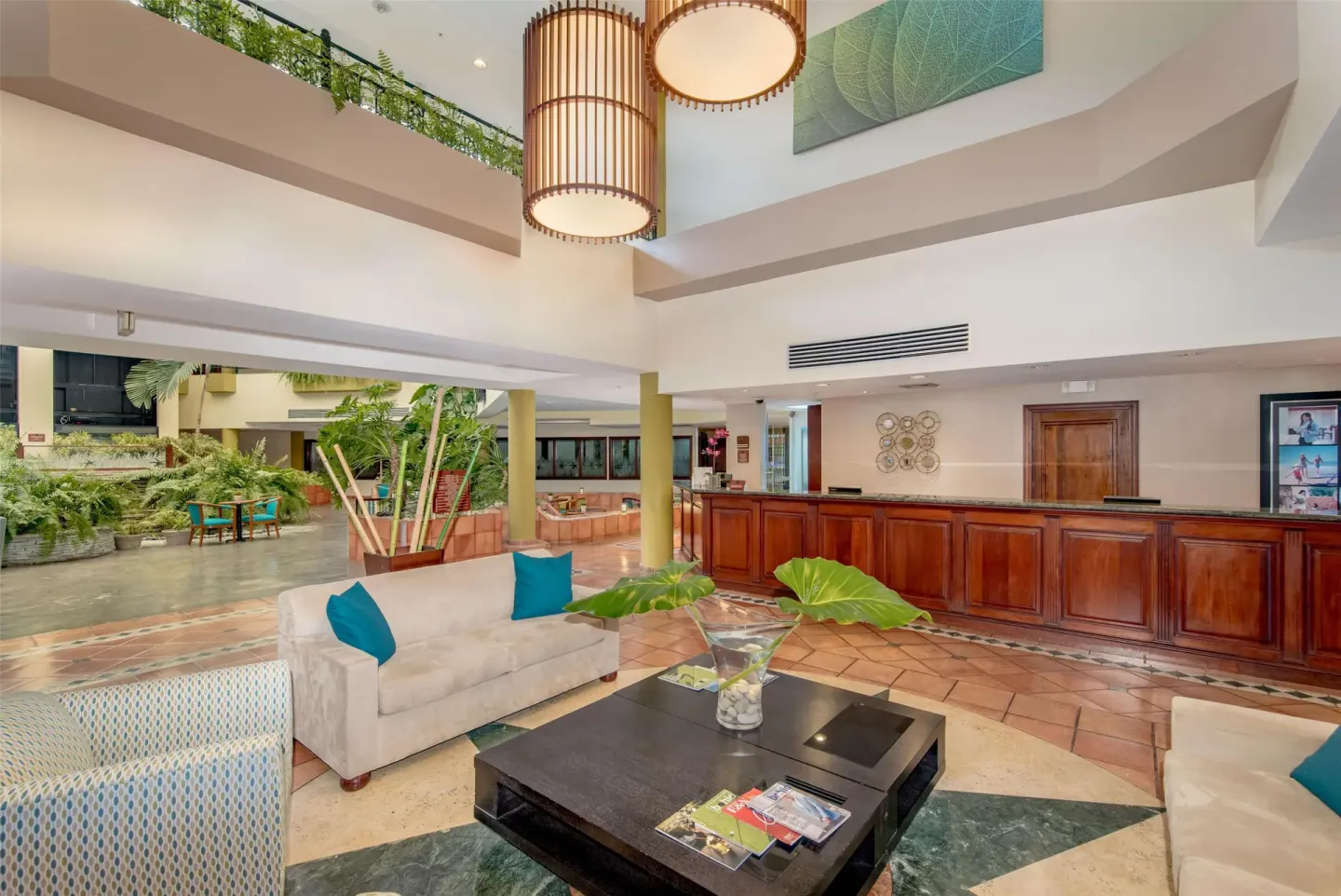 Wide lobby lounge and reception view at Hodelpa Garden Suites Golf & Convention Center.