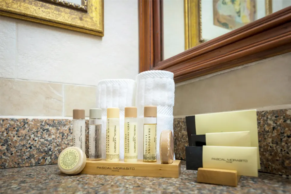 Royal Suite bathroom counter amenities at Hodelpa Garden Suites Golf & Convention Center.