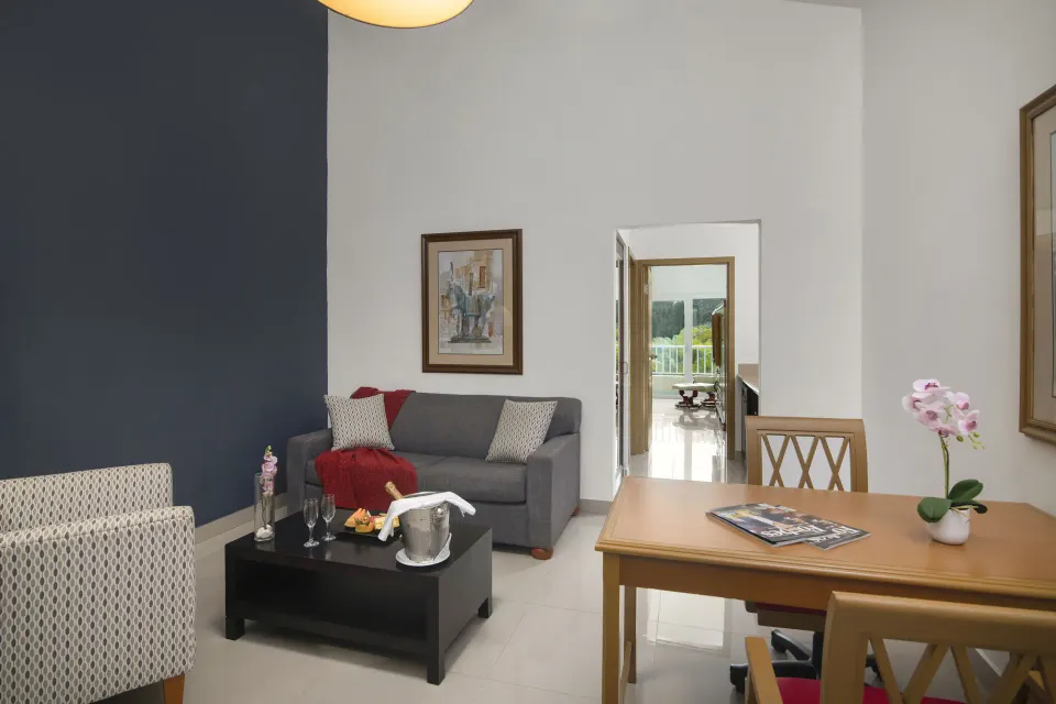 Royal Suite seating area with coffee table at Hodelpa Garden Suites Golf & Convention Center.