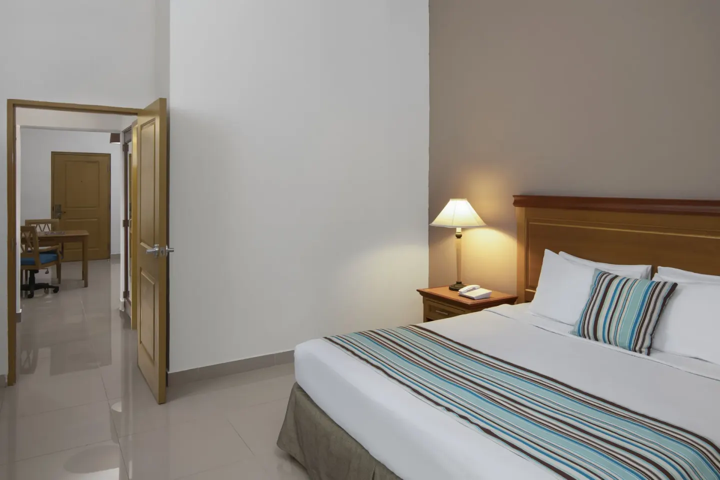 Suite Pool View bedroom with king bed at Hodelpa Garden Suites Golf & Convention Center.