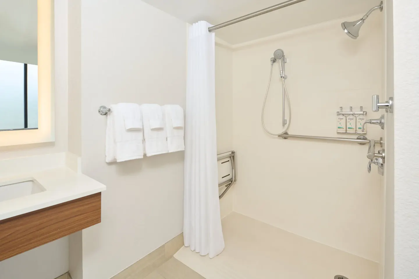 Accessible bathroom shower with towels at Holiday Inn Express Waikiki.