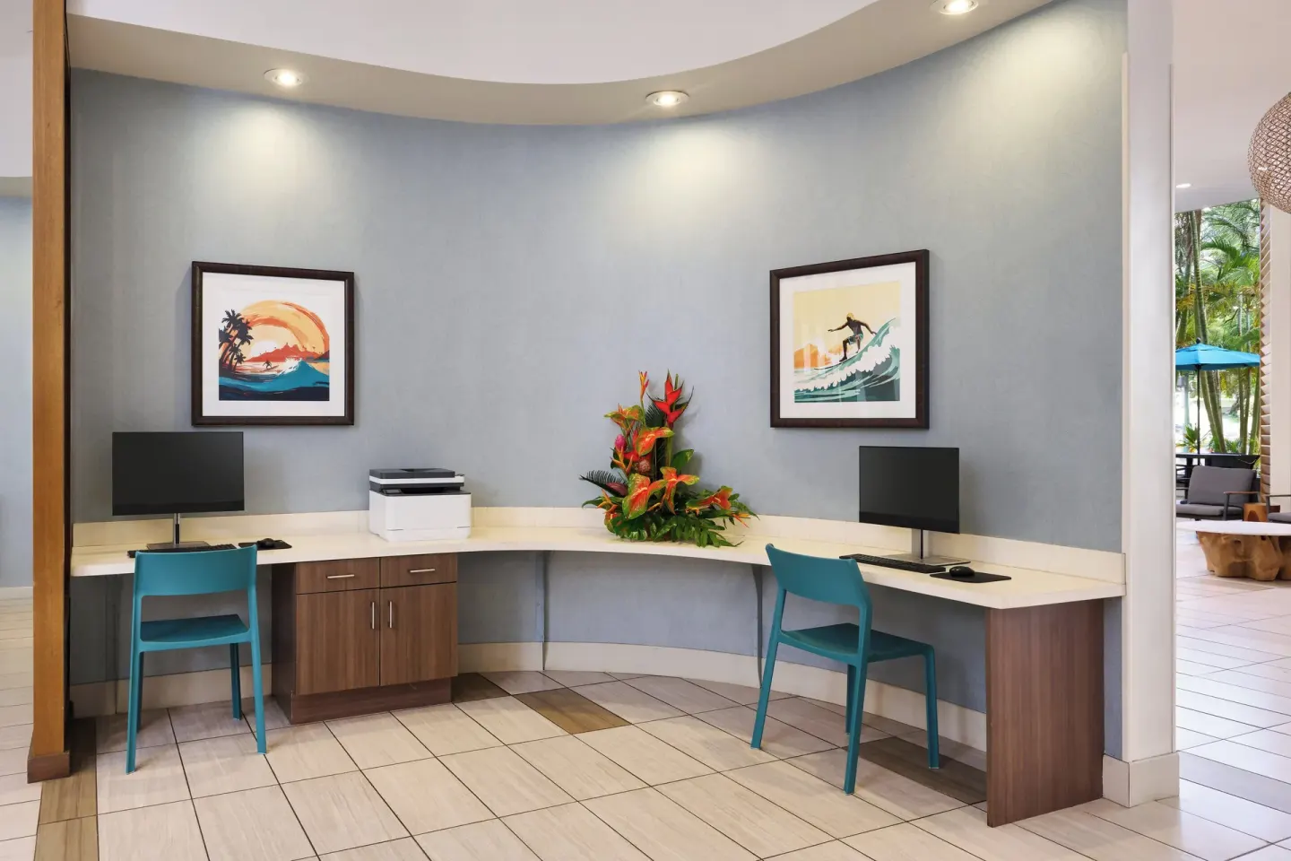Business center desks with computers and printer at Holiday Inn Express Waikiki.