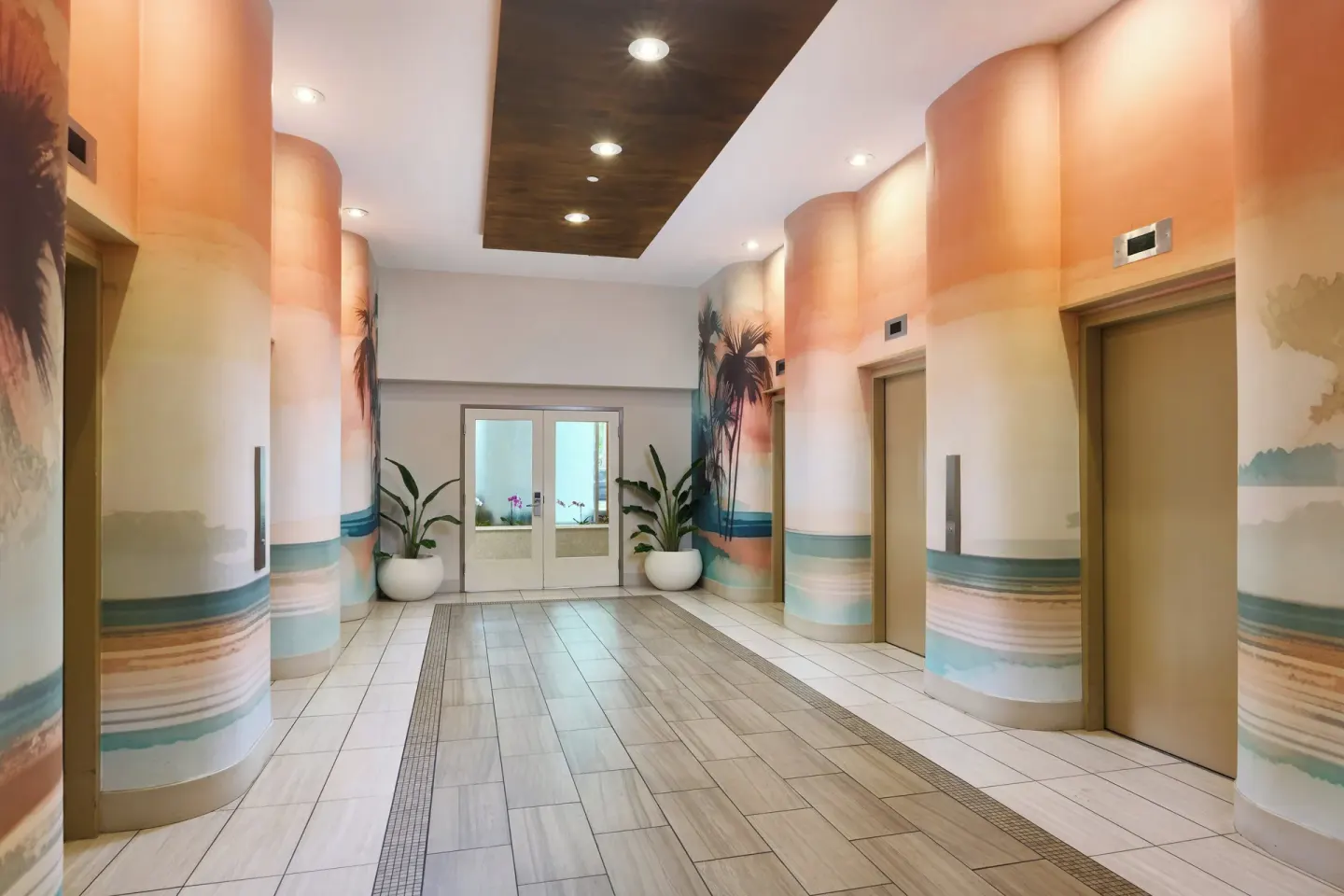 Elevator lobby with beach-themed wall murals at Holiday Inn Express Waikiki.