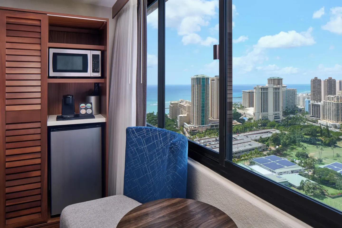 Guest room refreshment nook and city view window at Holiday Inn Express Waikiki.
