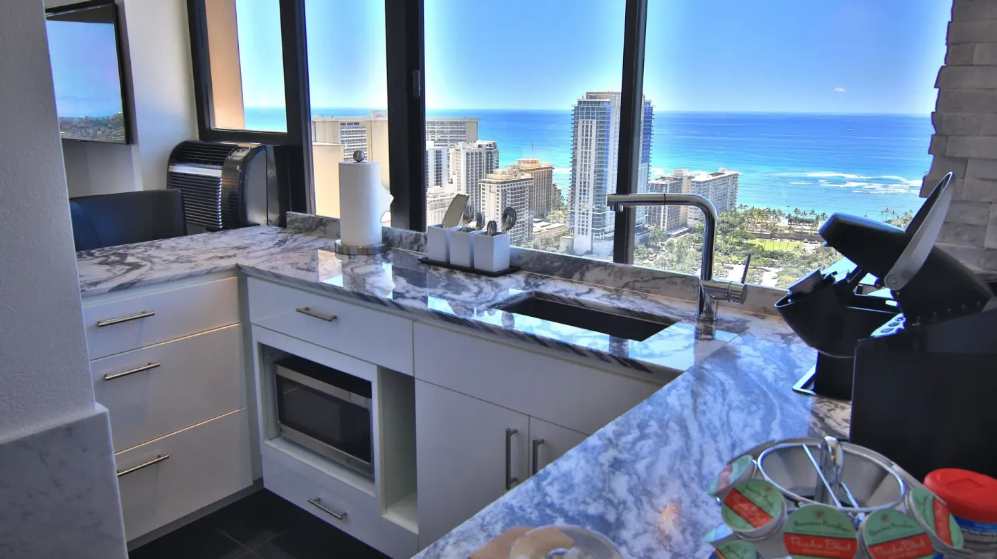 Kitchenette with marble-look counters and ocean view at Holiday Inn Express Waikiki.