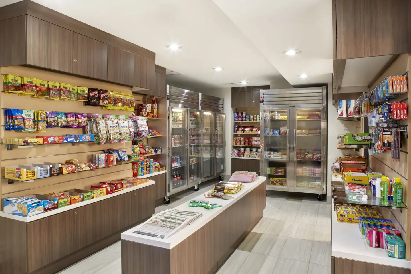 Market shelves with snacks, drinks, and toiletries at Holiday Inn Express Waikiki.