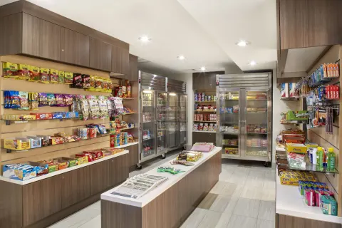 Market shelves with snacks, drinks, and toiletries at Holiday Inn Express Waikiki.