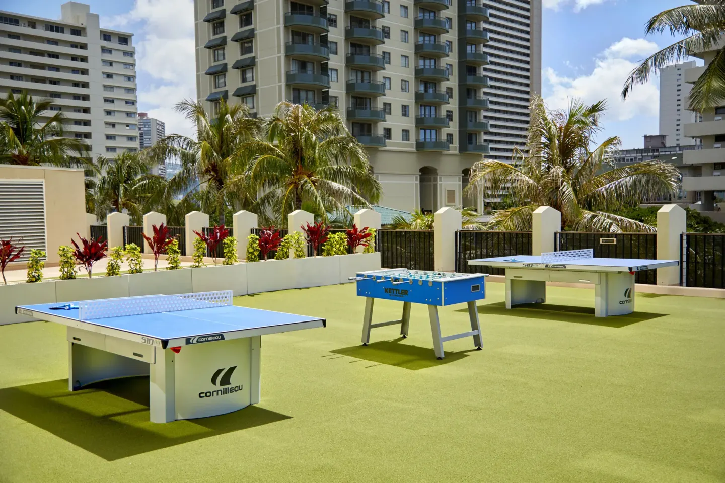 Outdoor game area with table tennis and foosball at Holiday Inn Express Waikiki.