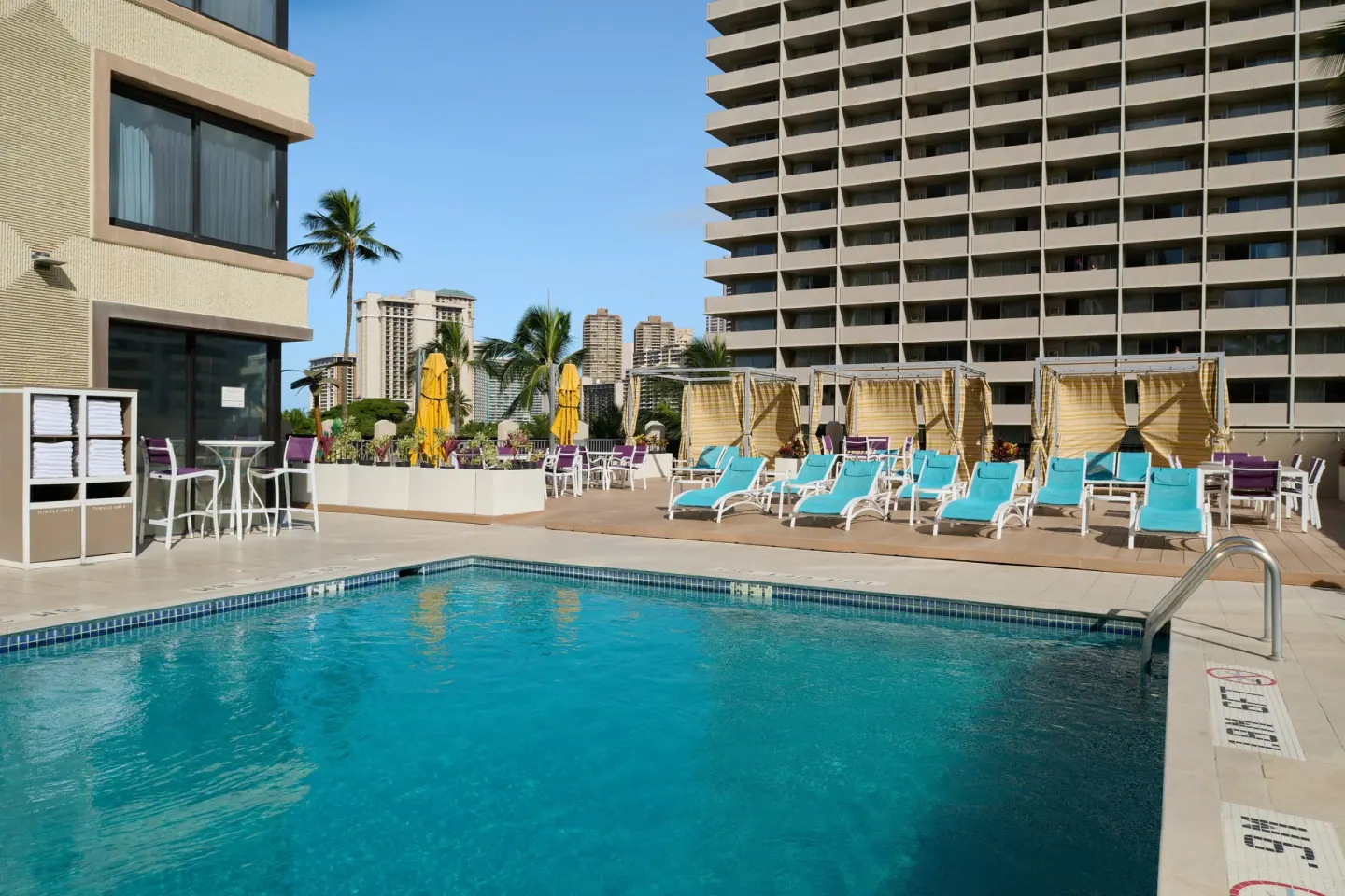 Pool and sun deck seating at Holiday Inn Express Waikiki.