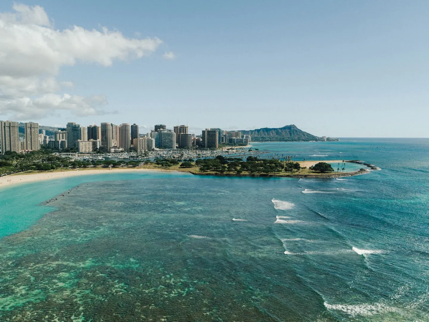 Aerial view of Waikiki shoreline, ocean, skyline, and Diamond Head near Holiday Inn Express Waikiki.