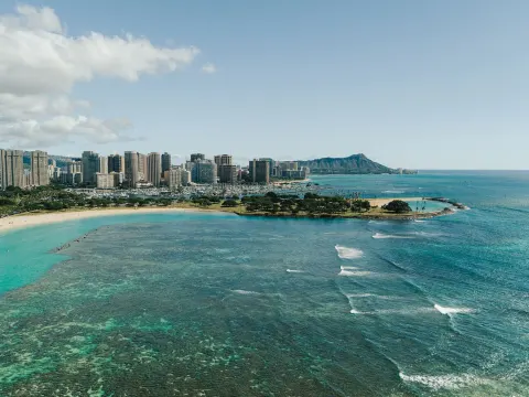 Aerial view of Waikiki shoreline, ocean, skyline, and Diamond Head near Holiday Inn Express Waikiki.