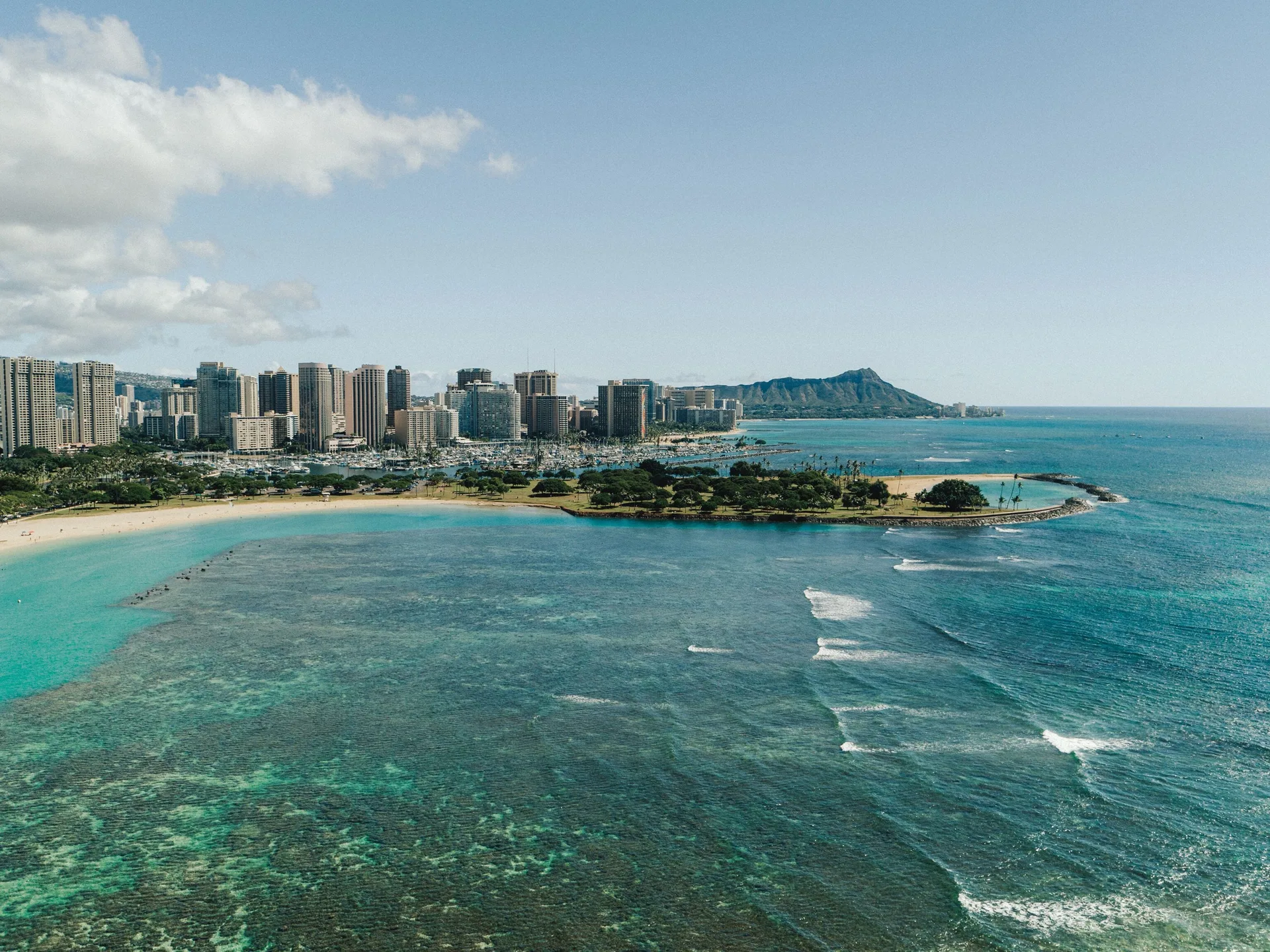 Aerial view of Waikiki shoreline, ocean, skyline, and Diamond Head near Holiday Inn Express Waikiki.