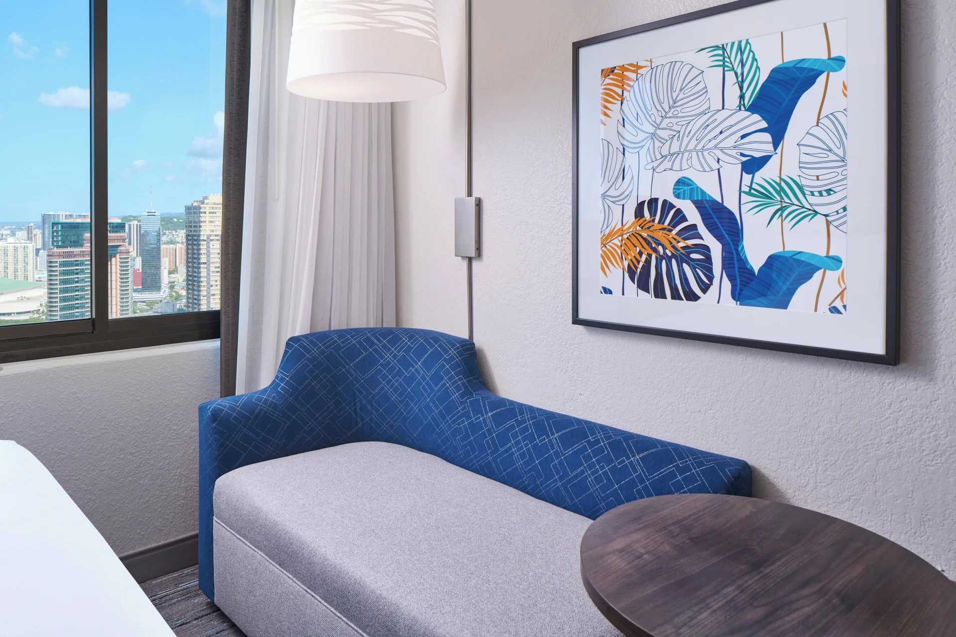 Standard Room chaise lounge by the window at Holiday Inn Express Waikiki.