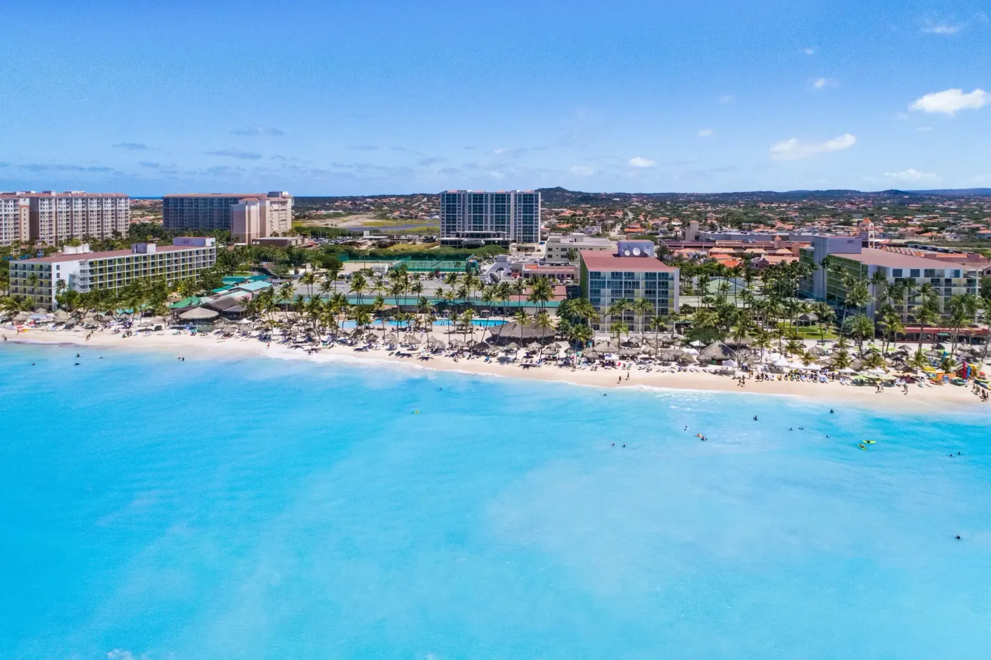 Aerial view of the beachfront resort and turquoise sea at Holiday Inn Resort Aruba - Beach Resort & Casino.