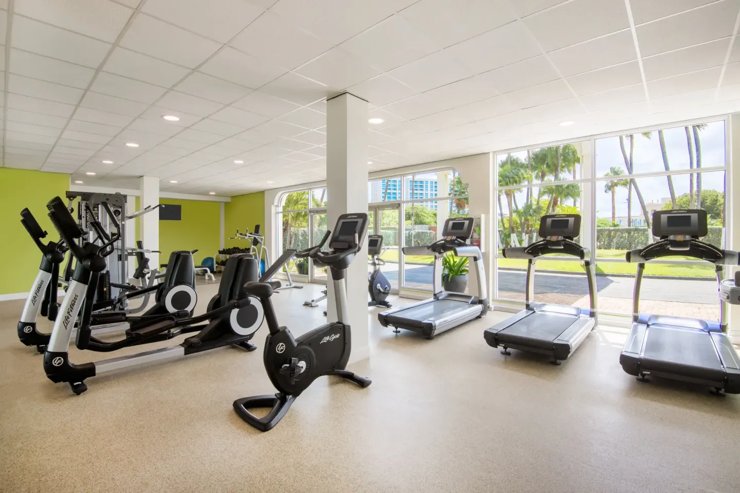 Fitness room with treadmills, bikes, and strength machines at Holiday Inn Resort Aruba - Beach Resort & Casino.
