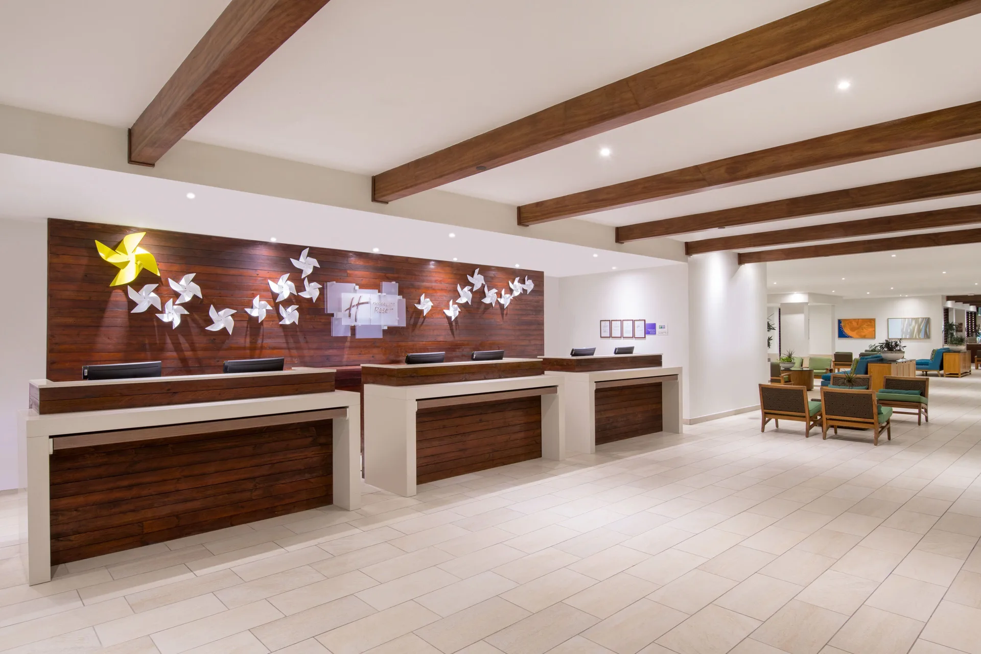 Lobby reception desks with wood accents at Holiday Inn Resort Aruba - Beach Resort & Casino.