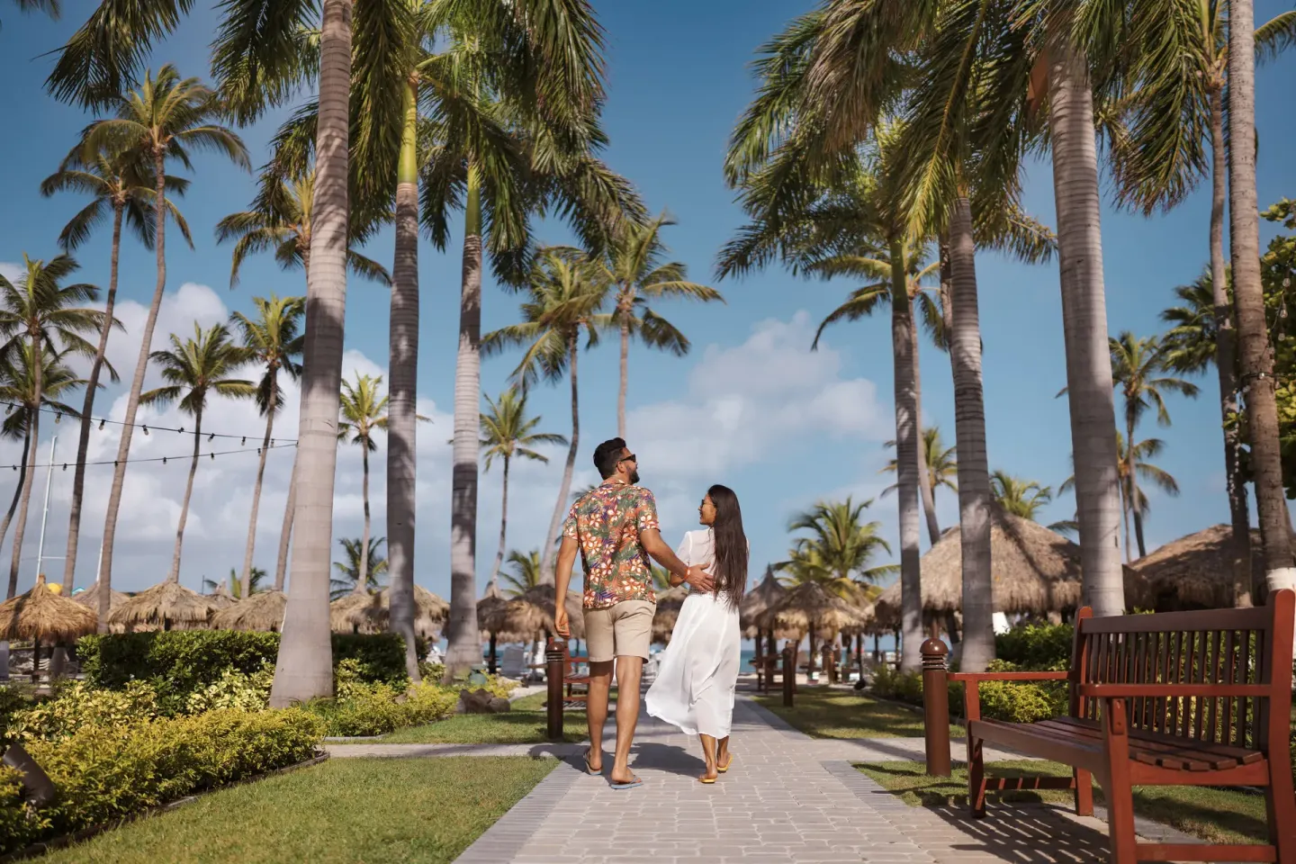 Palm-lined resort walkway at Holiday Inn Resort Aruba - Beach Resort & Casino.