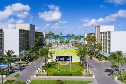 Resort entrance and buildings facing the ocean at Holiday Inn Resort Aruba - Beach Resort & Casino.