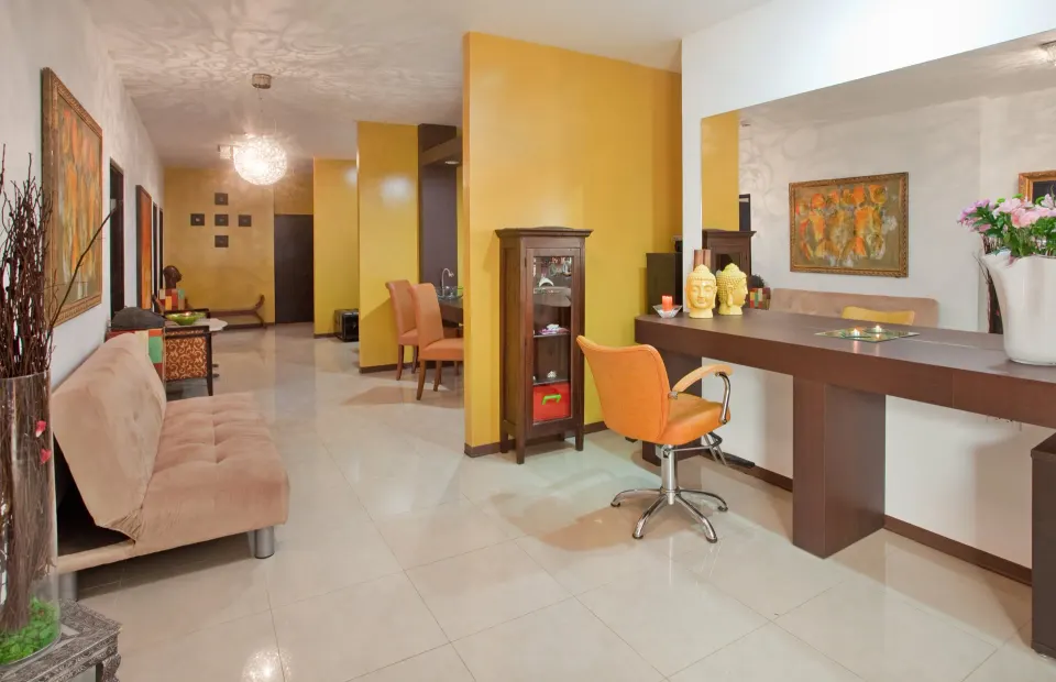 Spa-style salon lounge with chairs and mirrors at Holiday Inn Resort Aruba - Beach Resort & Casino.