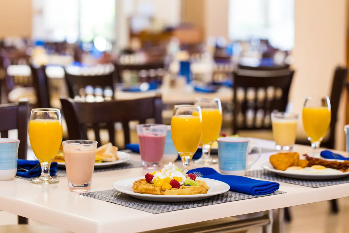 Breakfast table with juices and waffles at Holiday Inn Resort Aruba - Beach Resort & Casino.
