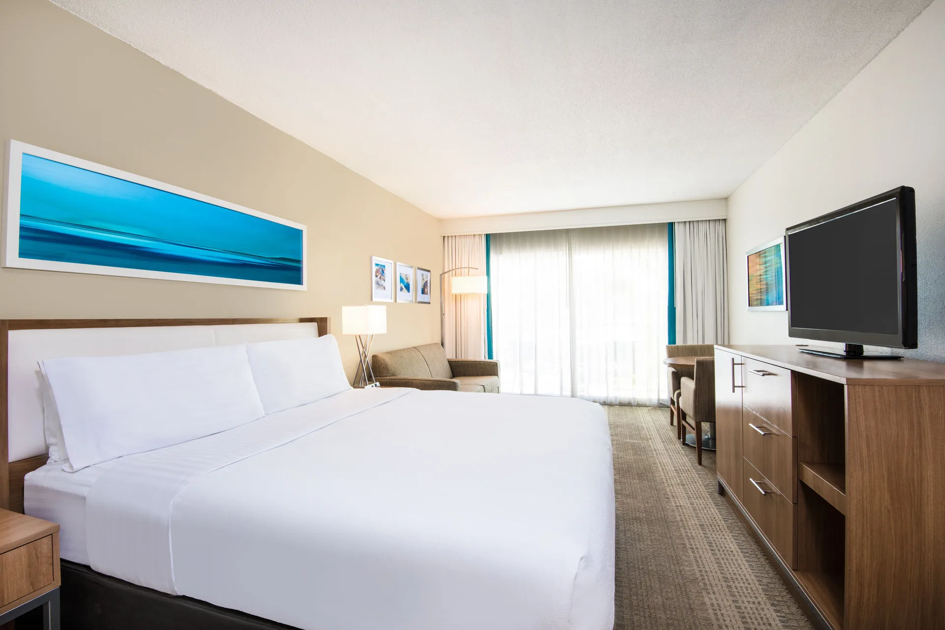 Premium Room king bed and seating at Holiday Inn Resort Aruba - Beach Resort & Casino.