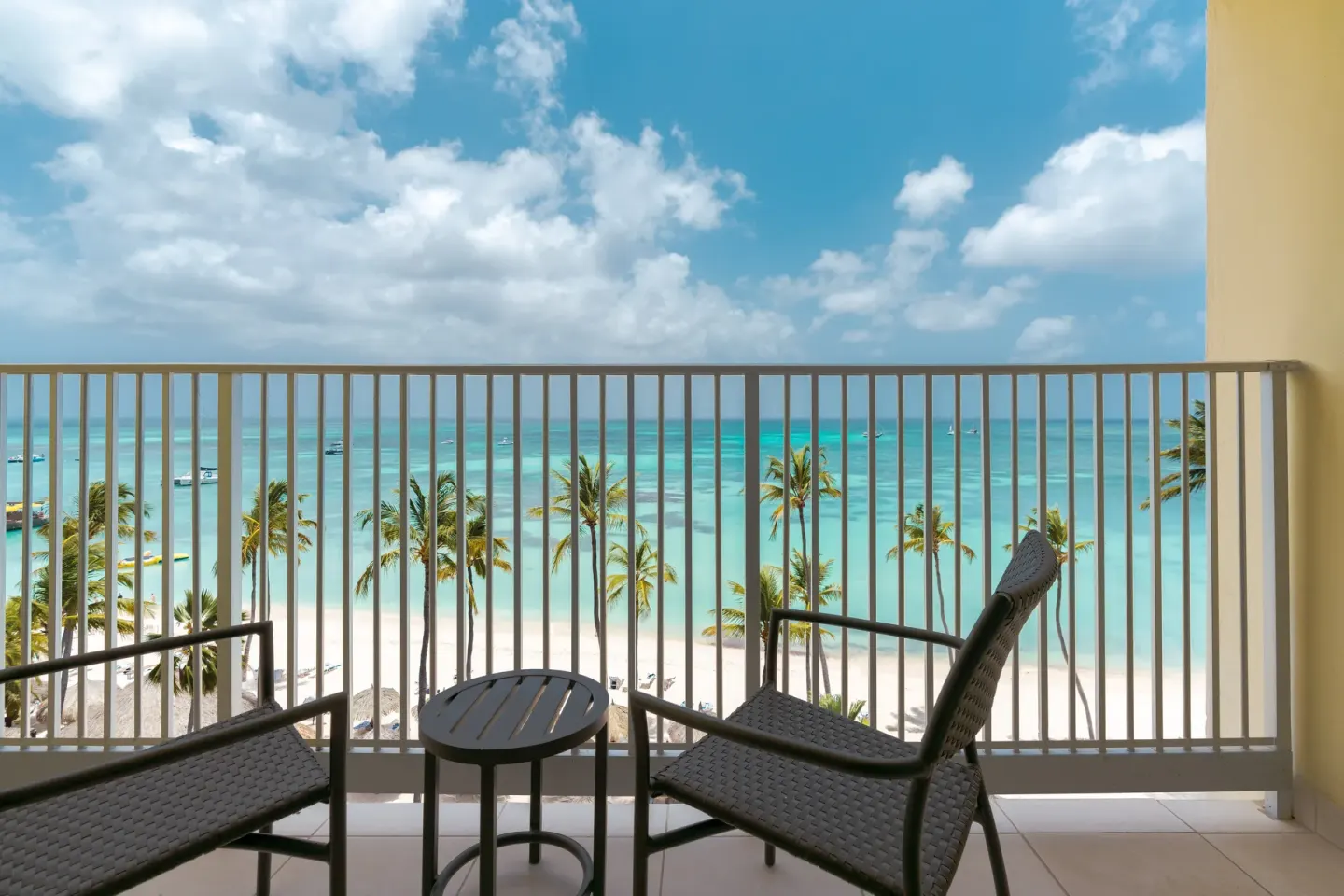 Oceanfront balcony with chairs at Holiday Inn Resort Aruba - Beach Resort & Casino.