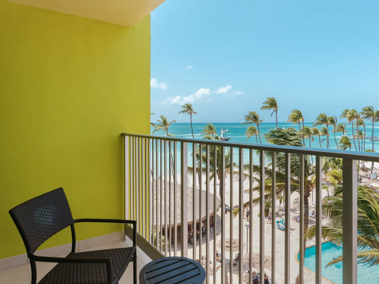 Partial ocean view balcony with chairs at Holiday Inn Resort Aruba - Beach Resort & Casino.