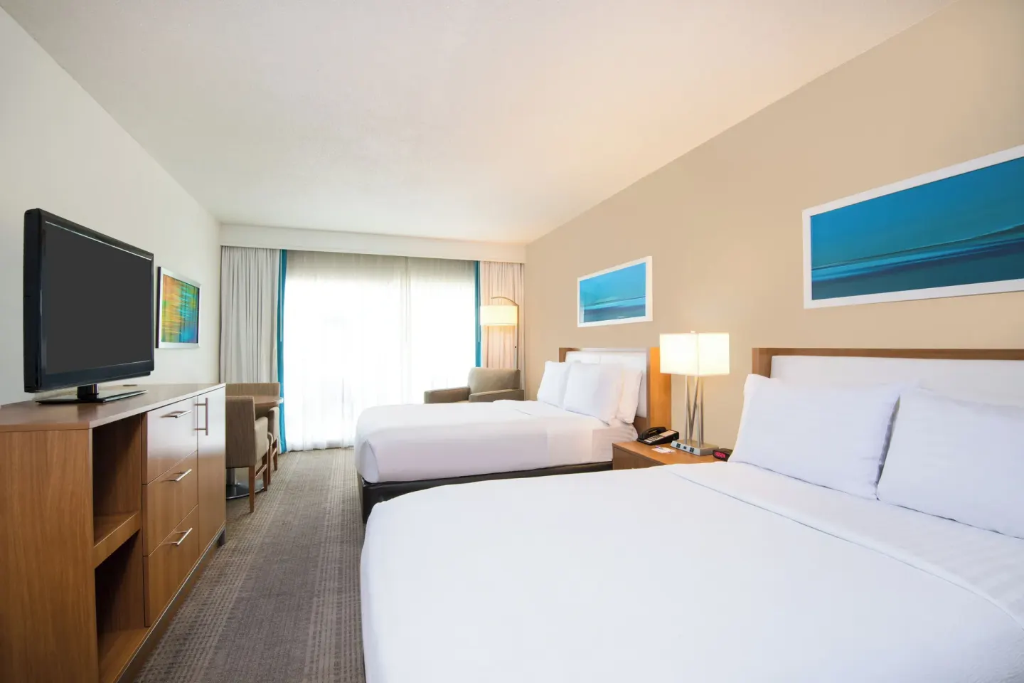 Standard Room with two beds and dresser TV at Holiday Inn Resort Aruba - Beach Resort & Casino.