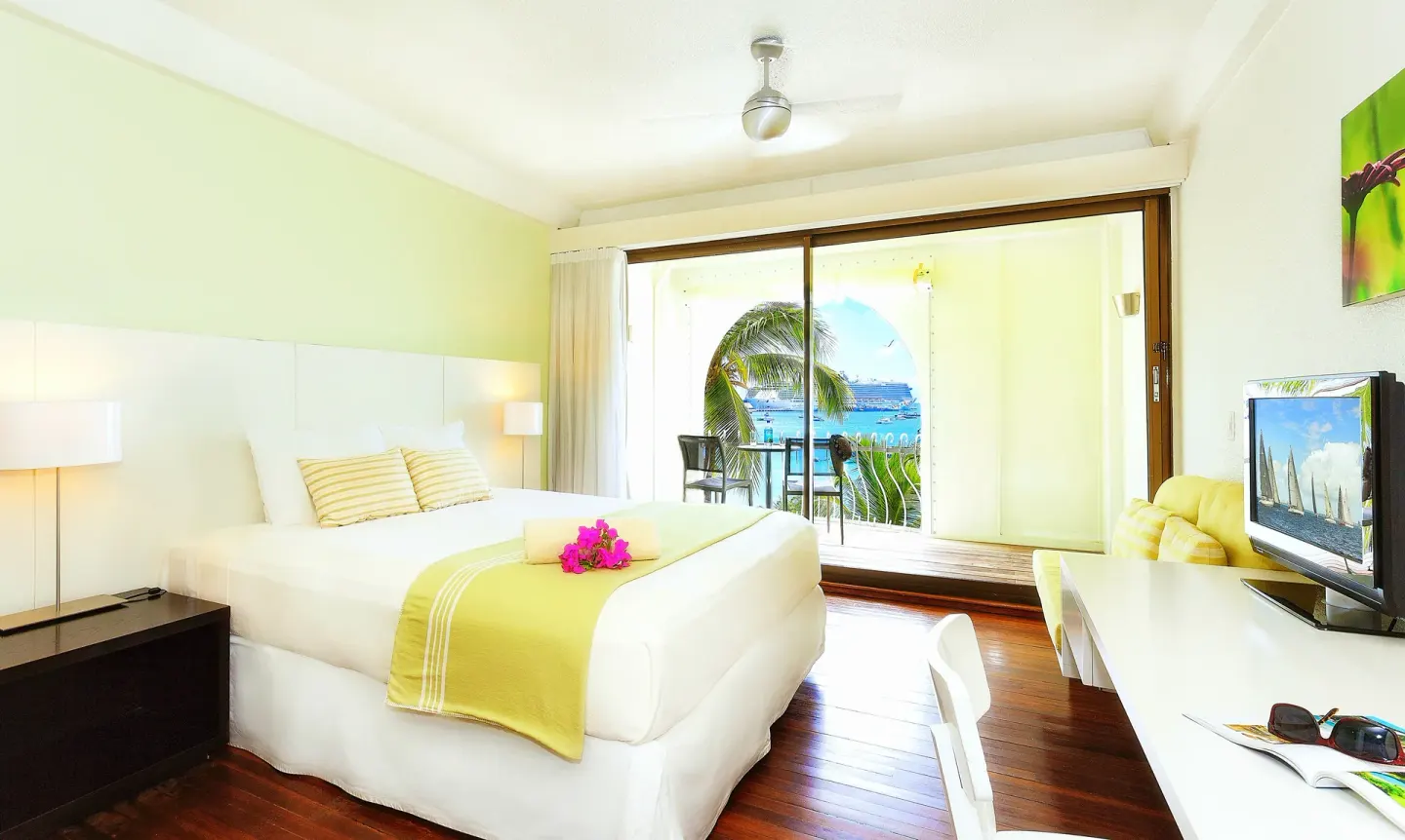 Deluxe Beach View room with king bed and balcony at Holland House Beach Hotel.