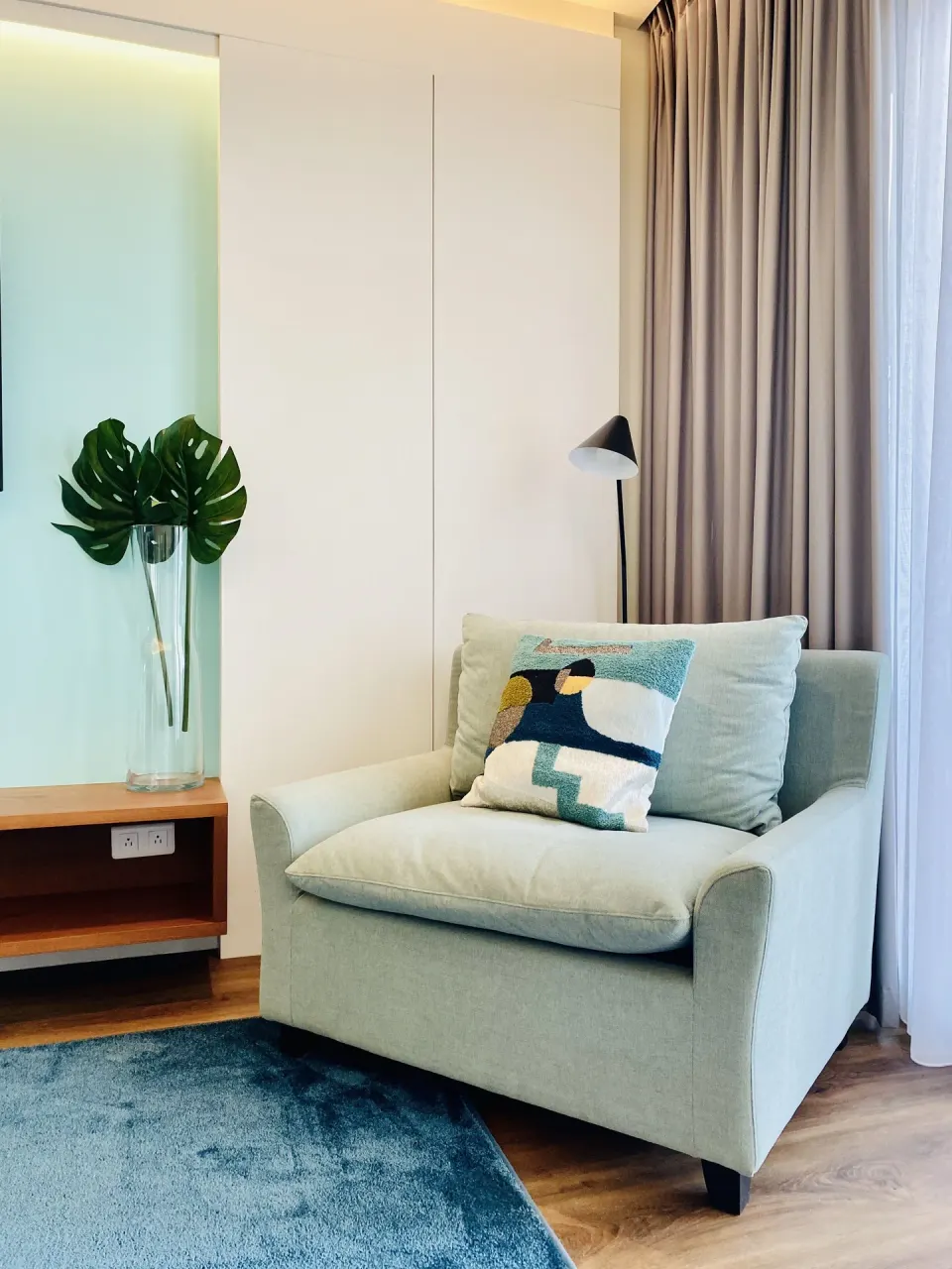 Executive Suite City View armchair by curtains and desk at Holland House Beach Hotel.