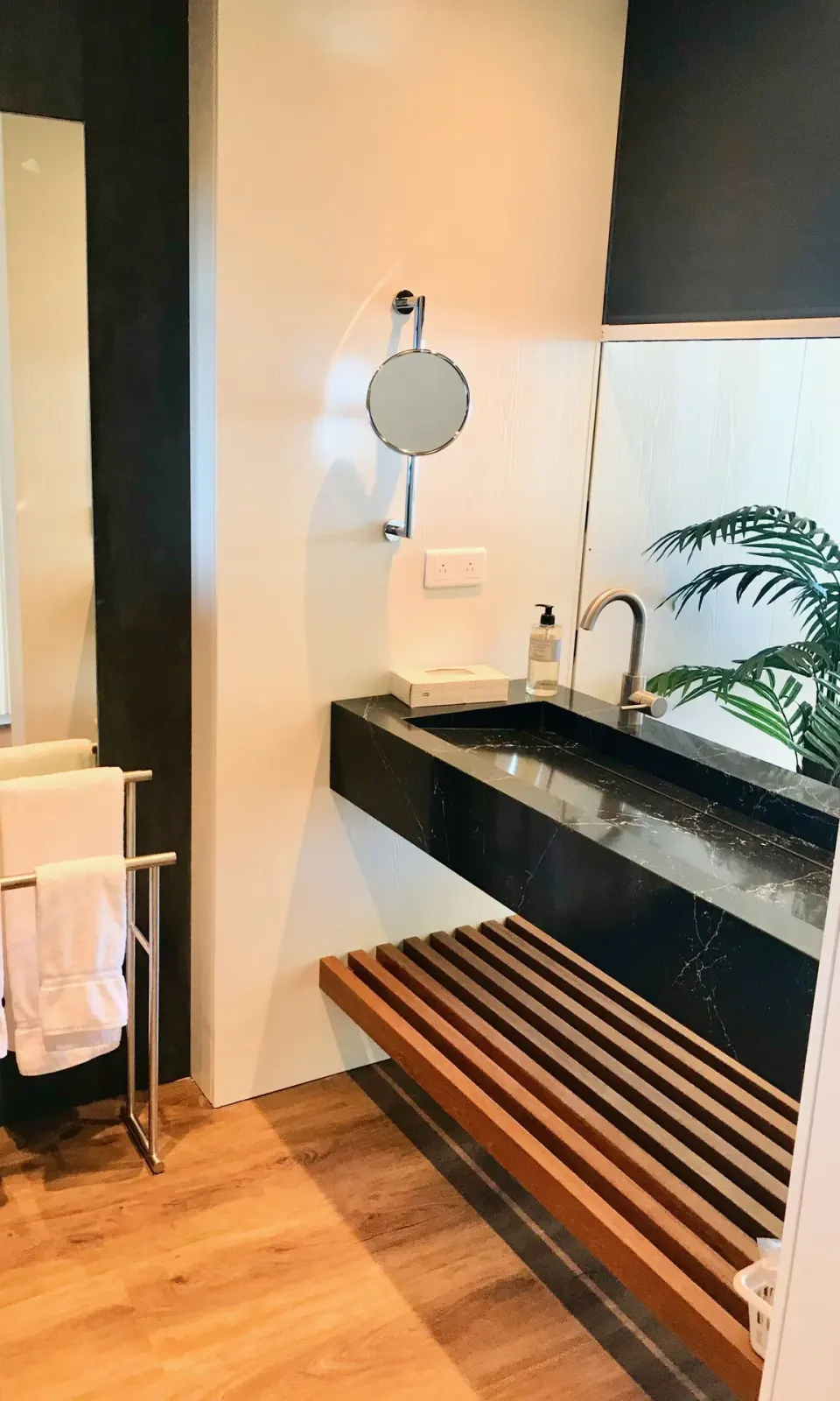 Executive Suite City View bathroom sink and towel rail at Holland House Beach Hotel.