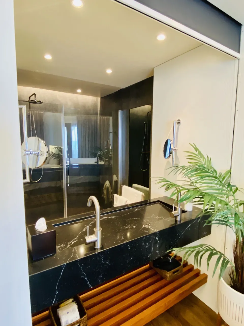 Executive Suite City View bathroom vanity and shower at Holland House Beach Hotel.
