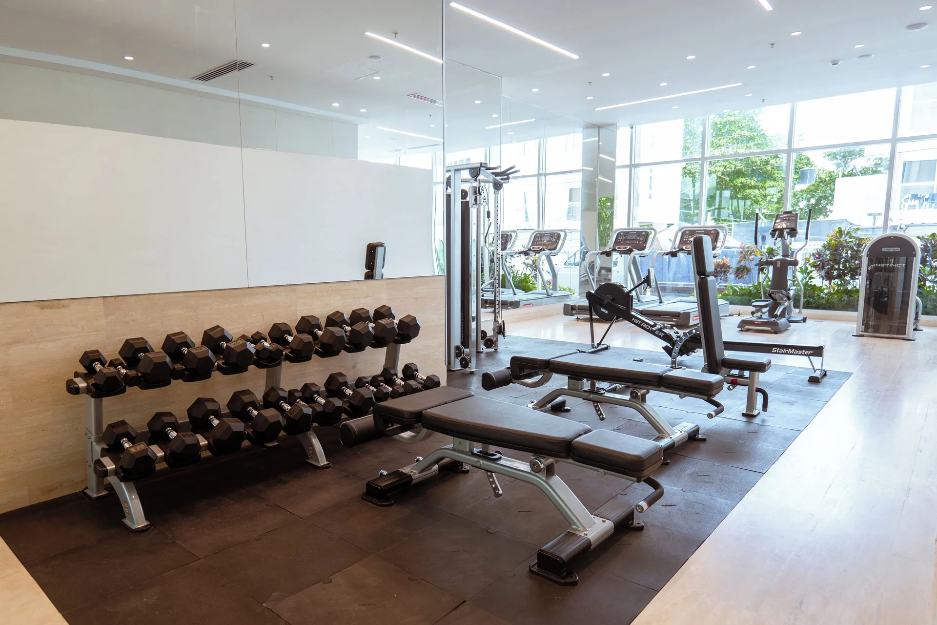 Fitness room with dumbbells, benches, and cardio machines at Hotel Arena Blanca.