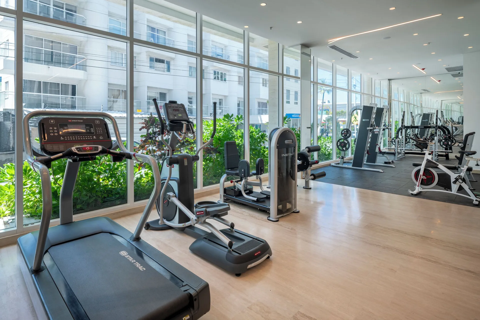 Gym with treadmills, strength machines, and large windows at Hotel Arena Blanca.
