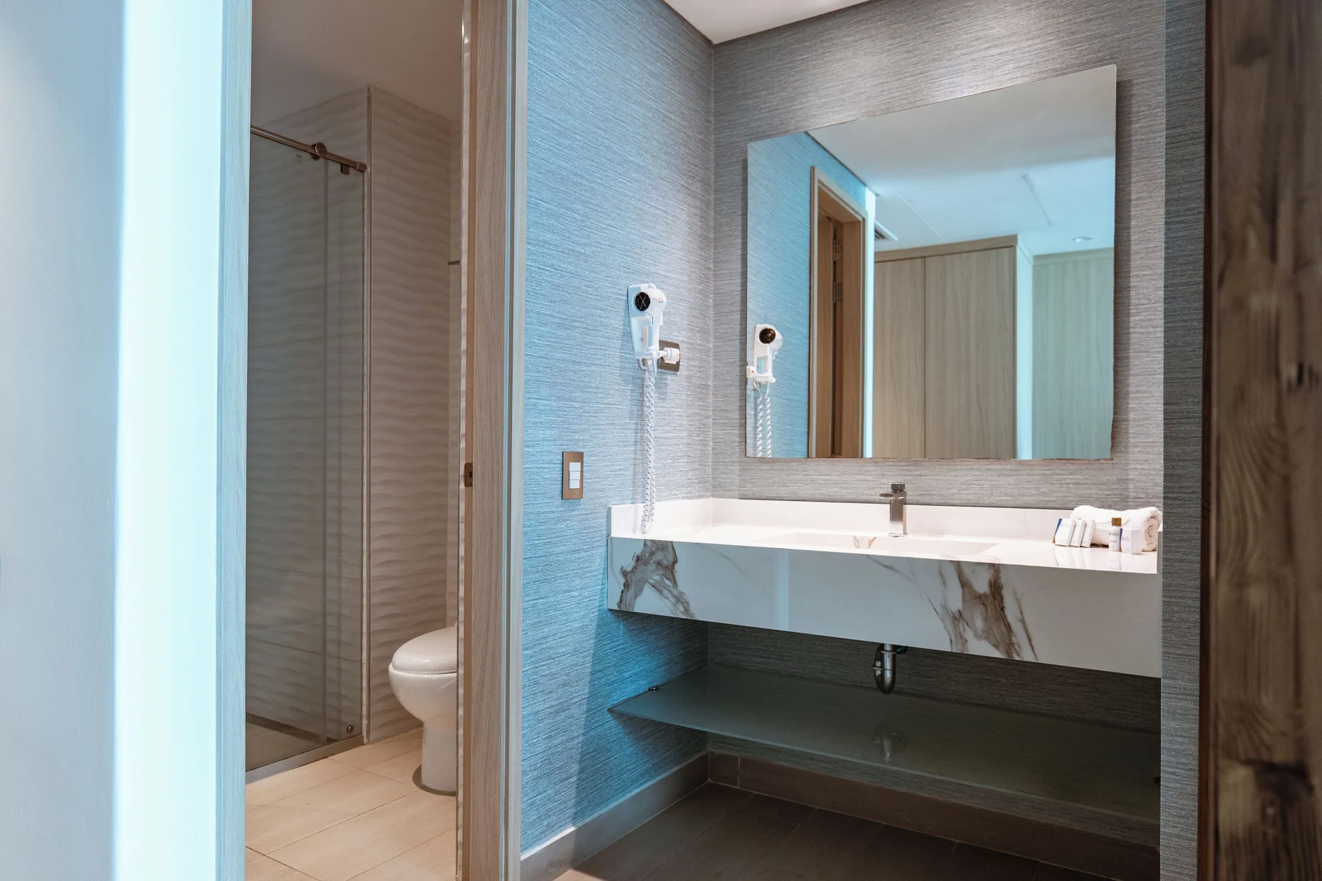 Superior Room bathroom vanity with shower and toilet visible at Hotel Arena Blanca.