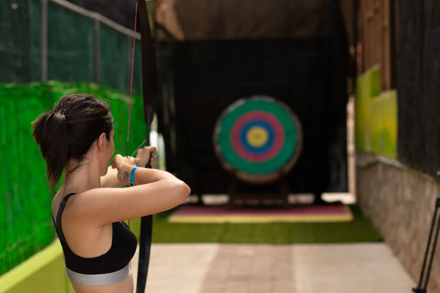 Guest aiming a bow at an archery target at Hotel Azul Ixtapa Grand Resort Spa.