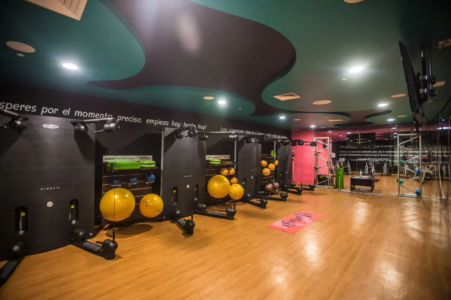 Fitness studio with wall equipment, exercise balls and wood flooring at Hotel Azul Ixtapa Grand Resort Spa.