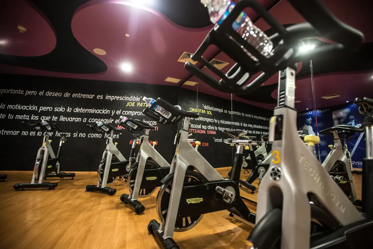 Indoor cycling room with stationary bikes and mirrored walls at Hotel Azul Ixtapa Grand Resort Spa.