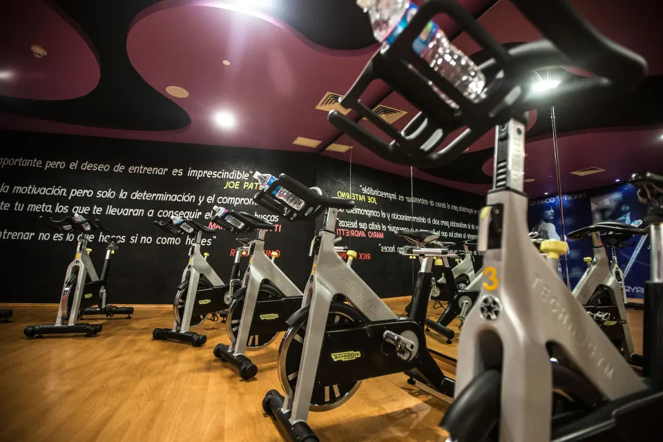 Indoor cycling room with stationary bikes and mirrored walls at Hotel Azul Ixtapa Grand Resort Spa.