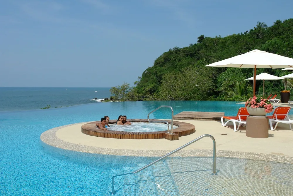 Infinity pool and round whirlpool overlooking the ocean at Hotel Azul Ixtapa Grand Resort Spa.
