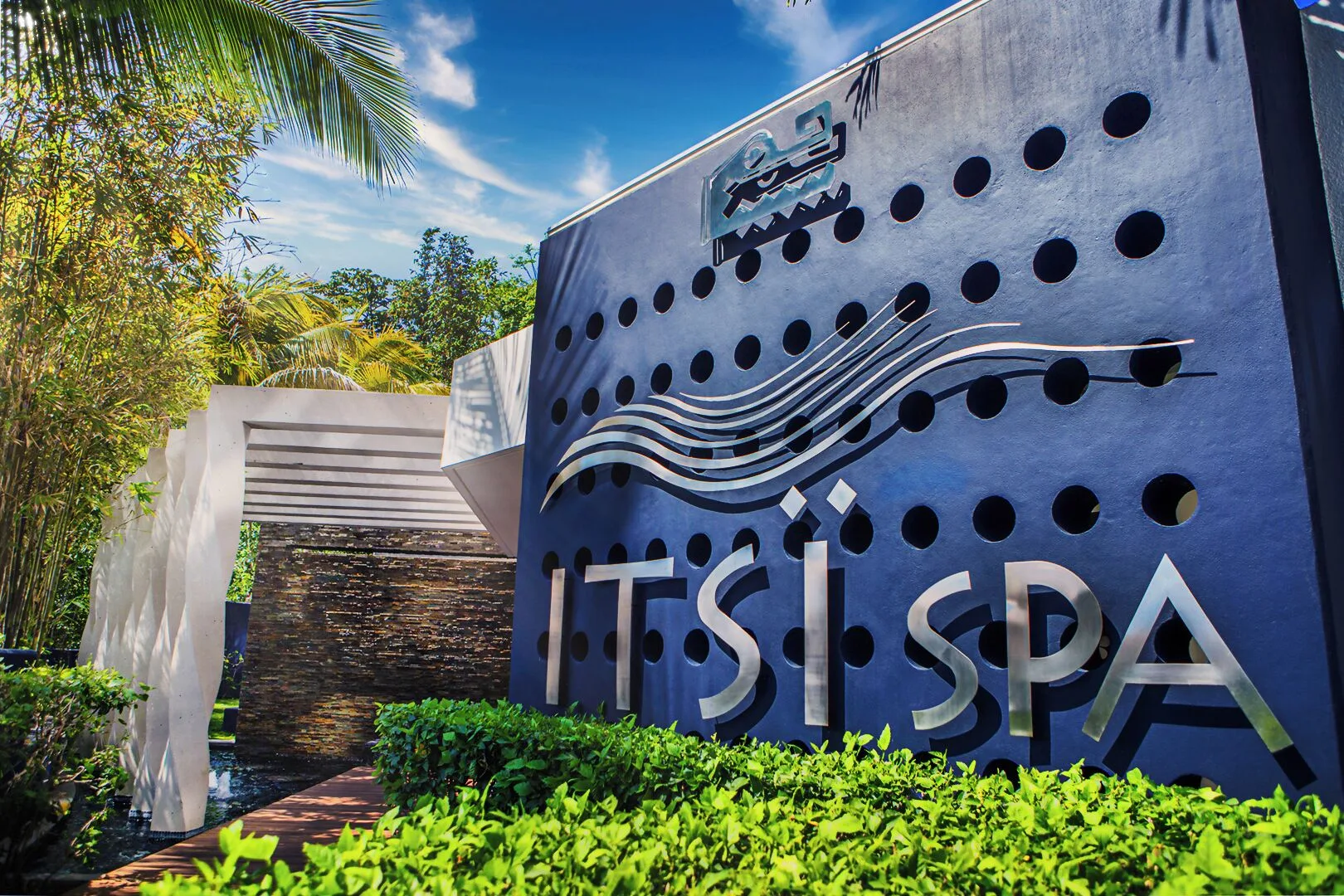 Itsï Spa exterior sign by tropical landscaping at Hotel Azul Ixtapa Grand Resort Spa.