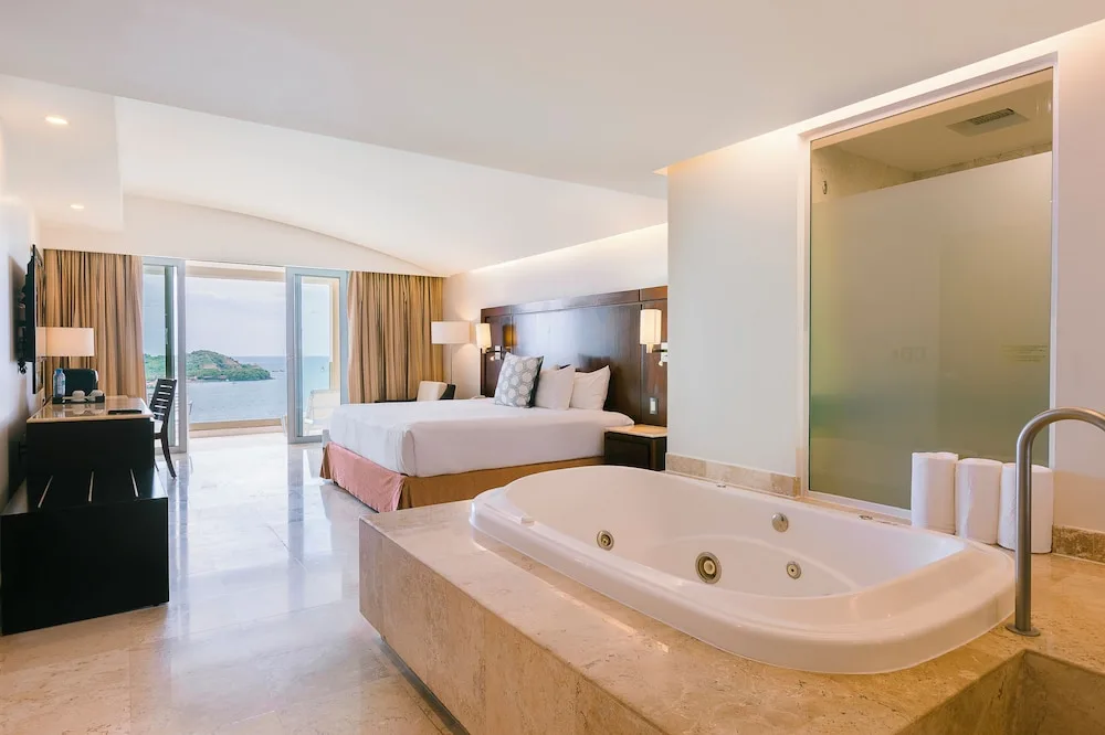 Ocean-view king guest room with jetted tub at Hotel Azul Ixtapa Grand Resort Spa.
