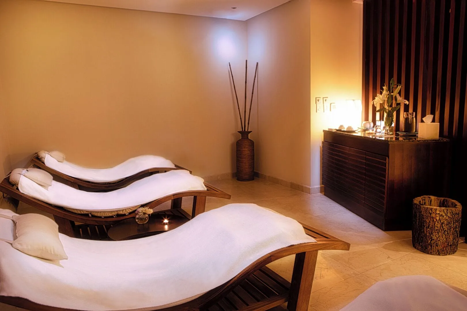 Spa relaxation room with curved loungers and warm lighting at Hotel Azul Ixtapa Grand Resort Spa.