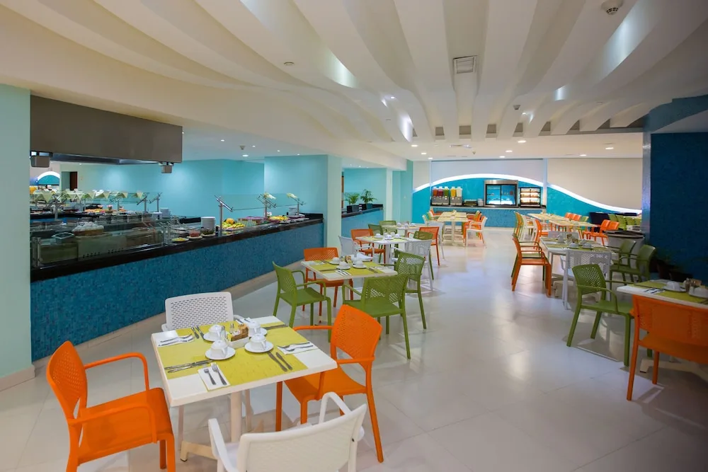 Bright buffet dining room with colorful chairs at Hotel Azul Ixtapa Grand Resort Spa.
