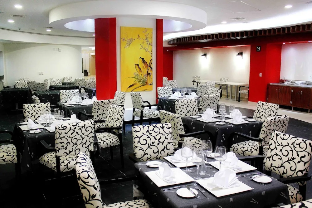 Asian-style restaurant dining room with red accents at Hotel Azul Ixtapa Grand Resort Spa.