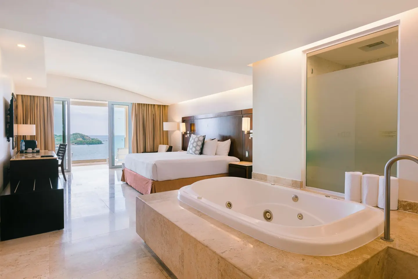 Luxury Room with king bed, in-room tub and ocean-view balcony at Hotel Azul Ixtapa Grand Resort Spa.