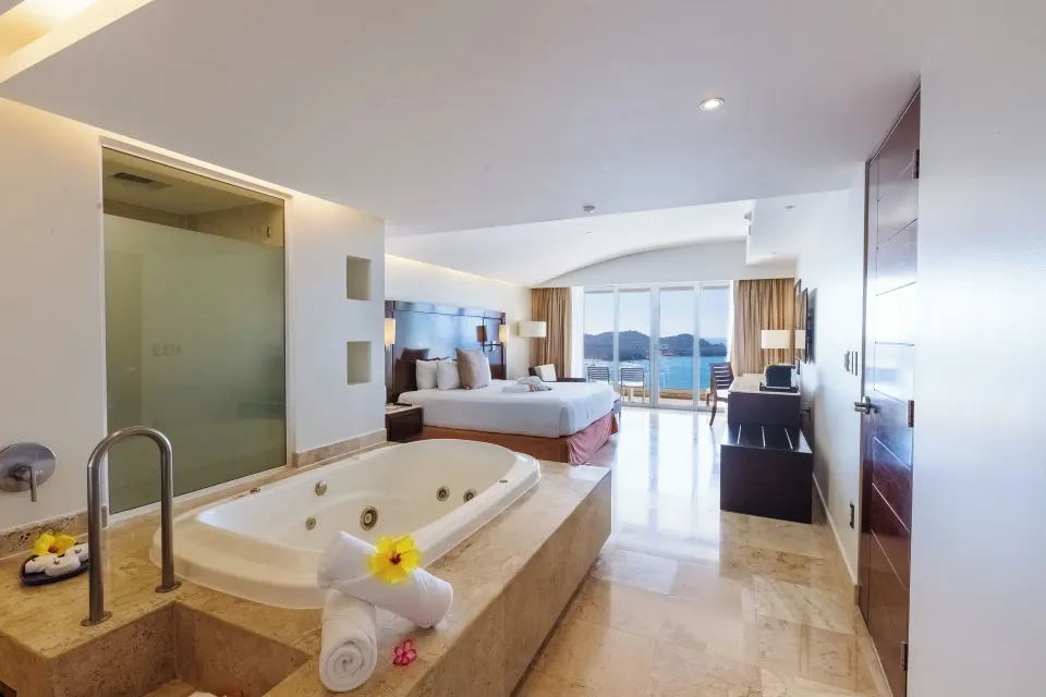 Luxury Room with king bed, jetted tub and balcony ocean view at Hotel Azul Ixtapa Grand Resort Spa.