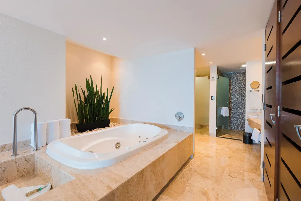 Luxury Suite bathroom with jetted tub and shower area at Hotel Azul Ixtapa Grand Resort Spa.