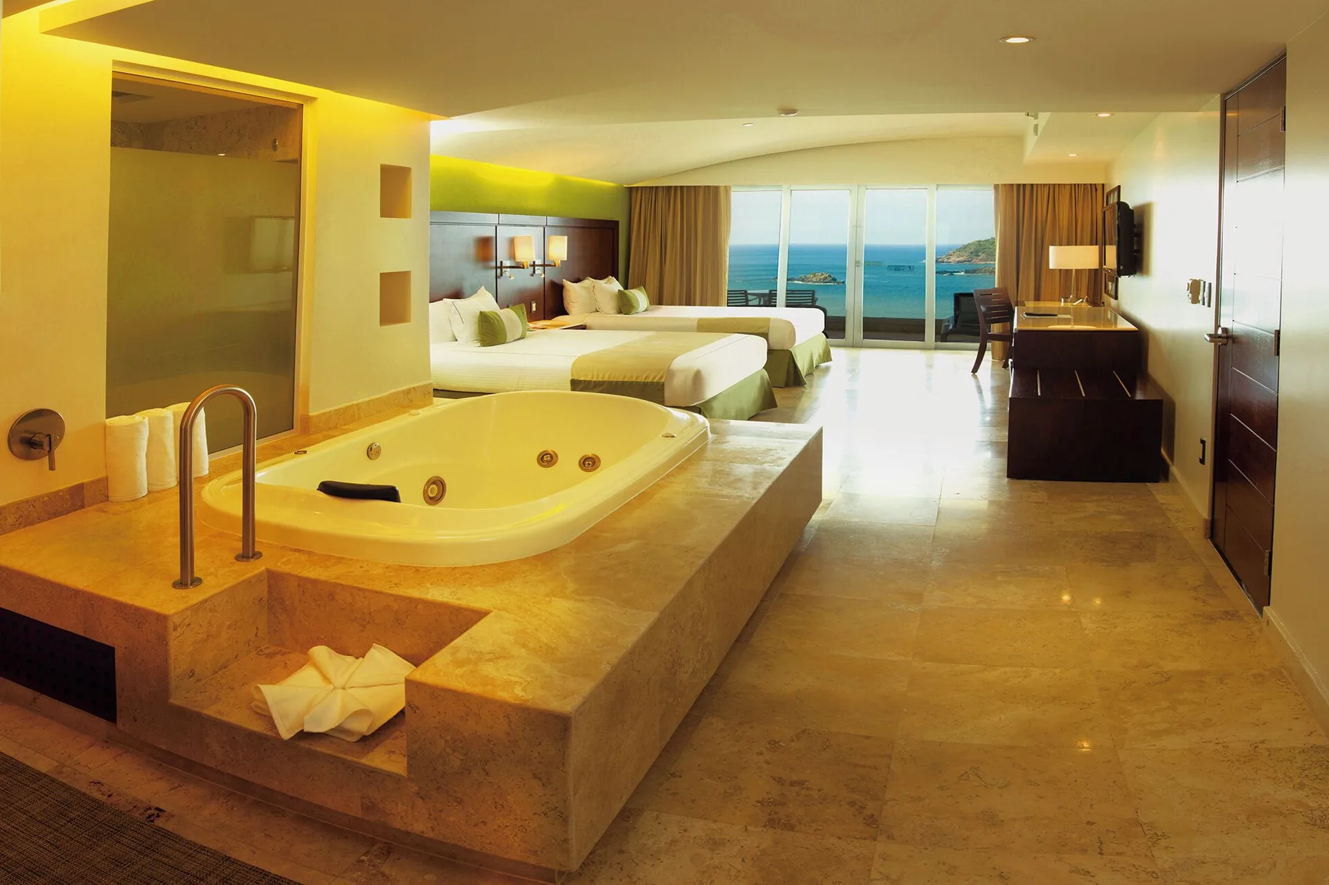 Luxury Suite with two beds, in-room jetted tub, and ocean view at Hotel Azul Ixtapa Grand Resort Spa.